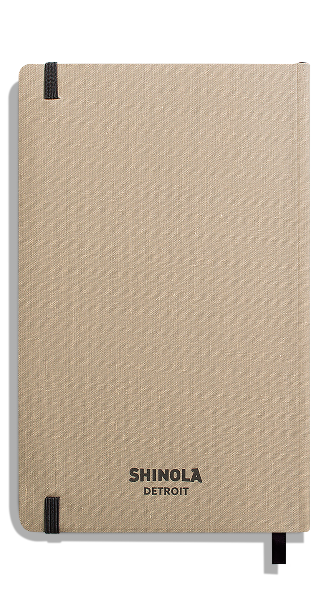 The Shinola Medium Soft Ruled Journal - Oat features a beige linen-textured hardcover, black elastic bands on the corners, acid-free paper, and "SHINOLA DETROIT" printed in black on the front.