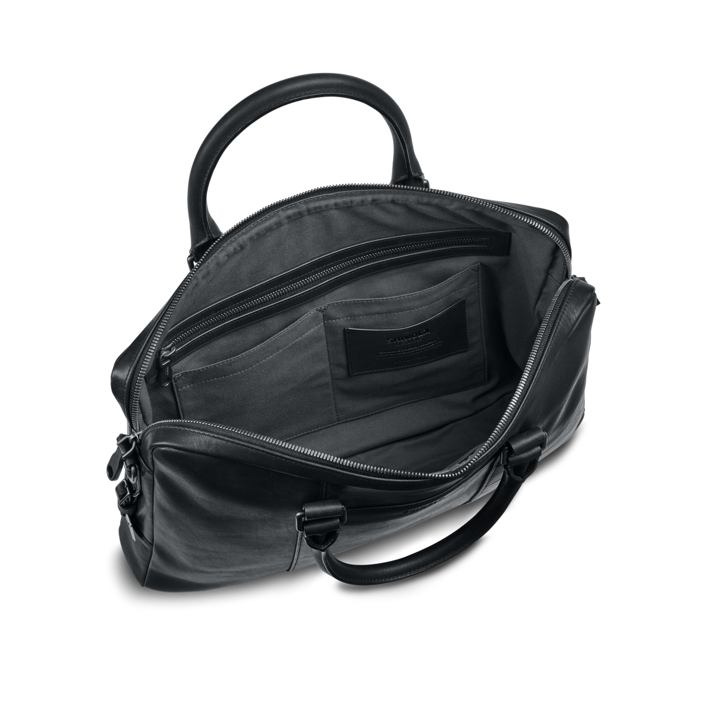 The shinola-jp.computer Briefcase - Black is shown open, displaying its spacious interior with multiple pockets. Featuring silver zippers, two sturdy handles, and a sleek modern design, it’s ideal as a stylish work bag.