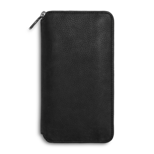 The Shinola Organizer Wallet - Black is a rectangular, natural grain leather zippered wallet with rounded edges and a textured finish, displayed closed against a white background.