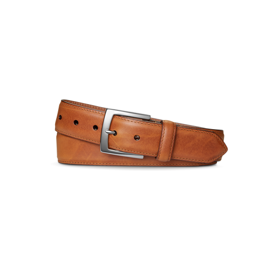 The Shinola 1 1/2" Bedrock Belt in Bourbon features signature leather and a sleek silver-toned buckle, neatly rolled and displayed on a plain white background.